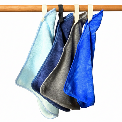 Four microfiber cloths in blue, gray, and black hanging on a wooden rod against a white background.