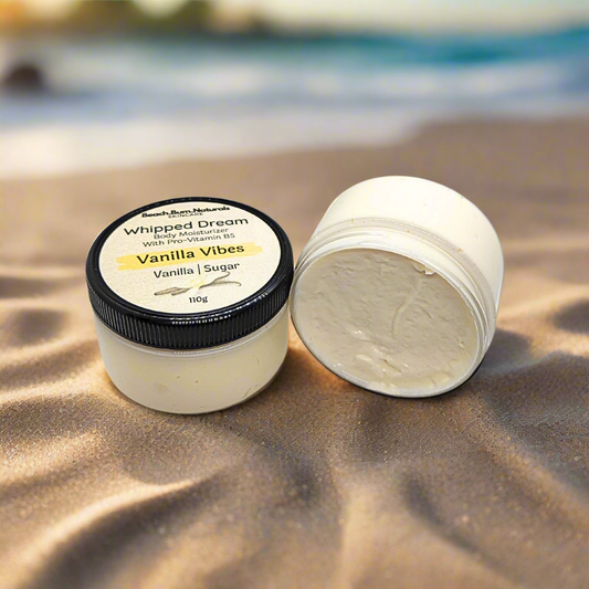 Jar of 'Vanilla Vibes' whipped body moisturizer with a black lid on a white background